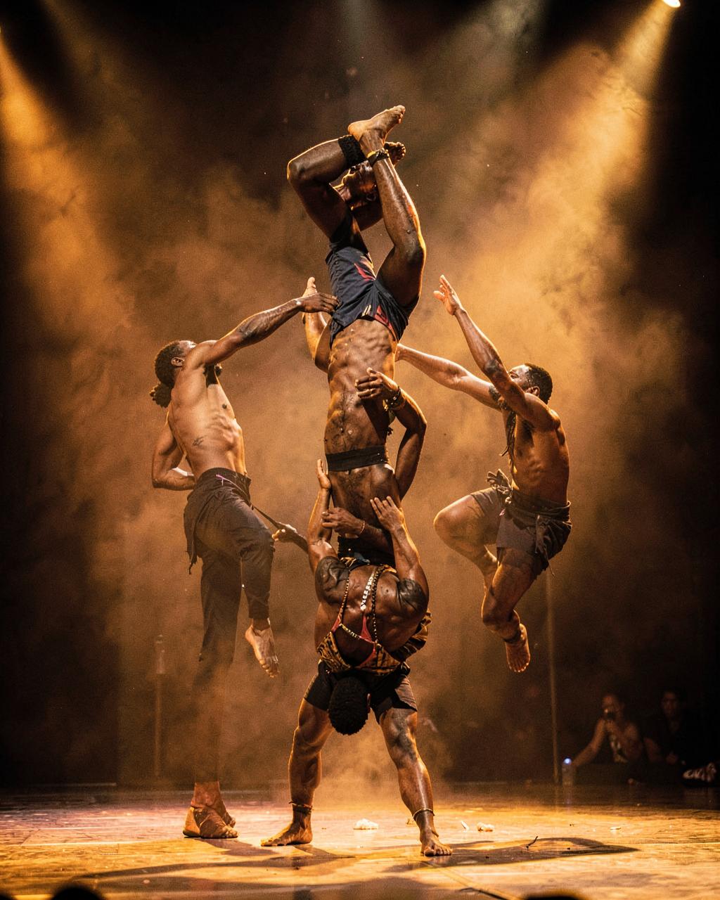 DRSTRIO artists forming an acrobatic human pyramid